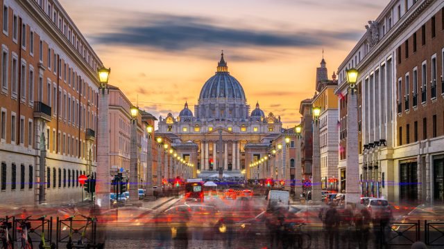 Vatican City, a city-state surrounded by Rome, Italy, with St. Vatican City, a city-state surrounded by Rome, Italy, with St. Peter's Basilica at twilight.